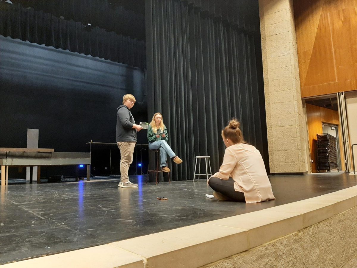 Forster directs Junior Carly Wenninger and Sophomore Everett Brown during a scene rehersal. 