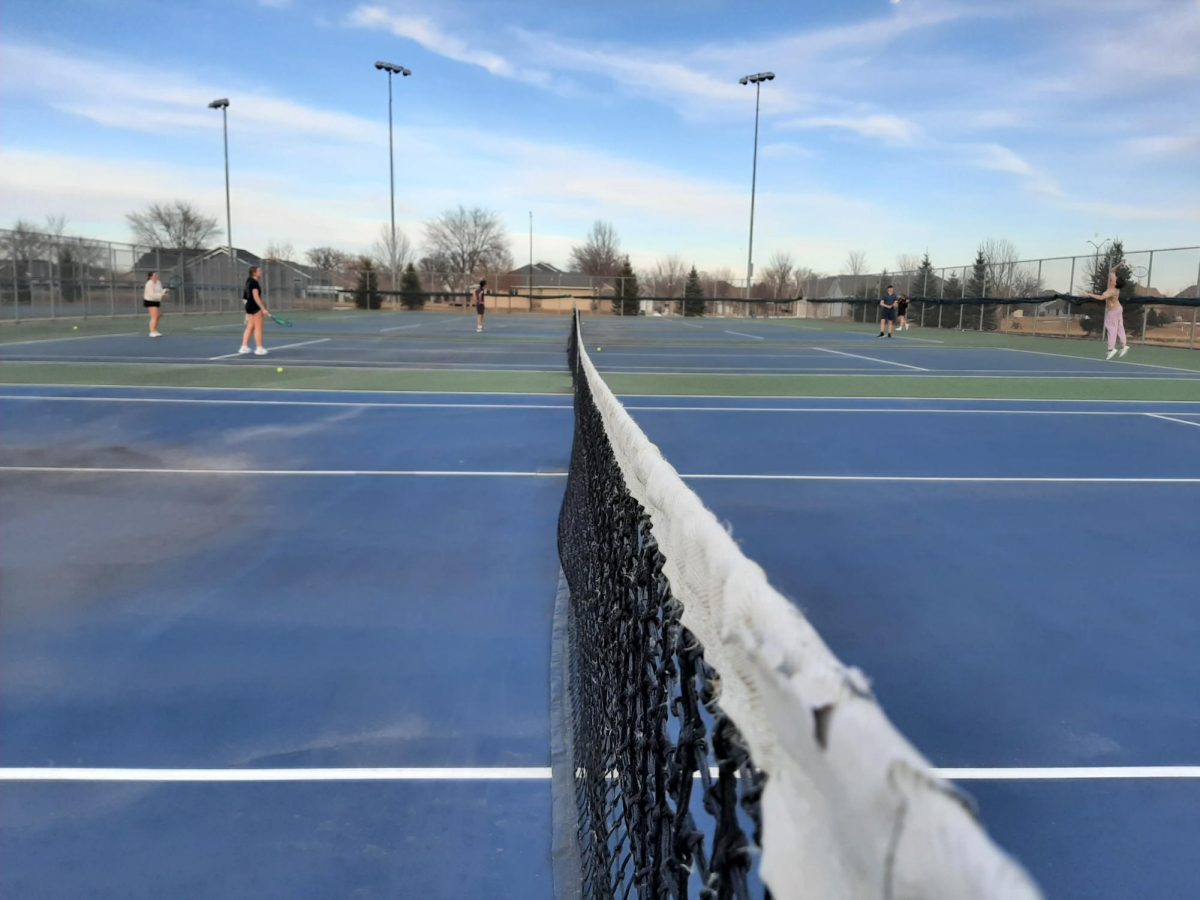 Tennis players enjoy the nets outside for the first time they are available.