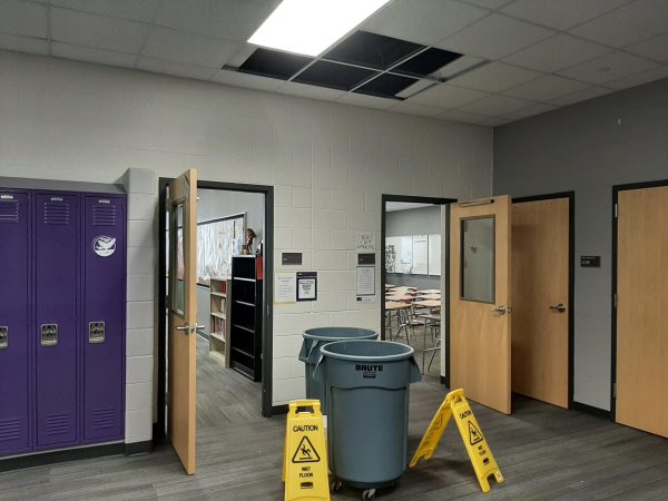 Buckets and caution signs are put up outside of classrooms to collect the discharge. 