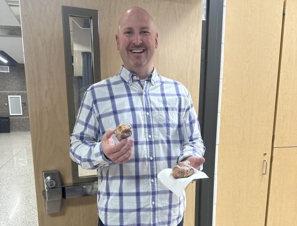 Mr. Nelson eating a donut provided by student council during teacher appreciation week. 