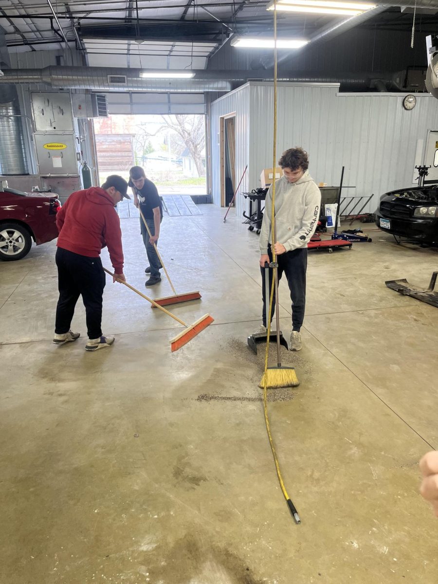 Lucas Sundag-Bode, Phoenix Black, and Kellan Bode cleaning up the shop floor