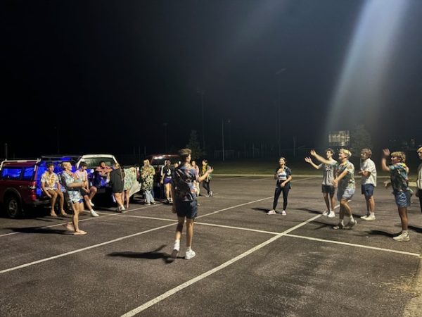 New Ulm High School Students play a game of four square in the parking lot after the volleyball team's win over Fairmont on Tuesday night.