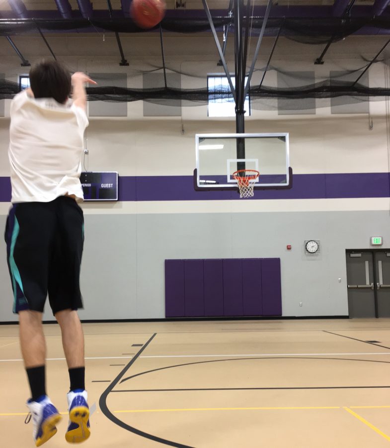 Senior guard Alex Lund launches a three-pointer in practice.