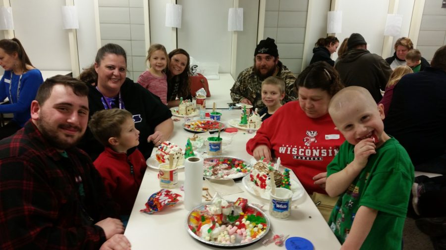 Jordan Rummel helping his students build gingerbread houses