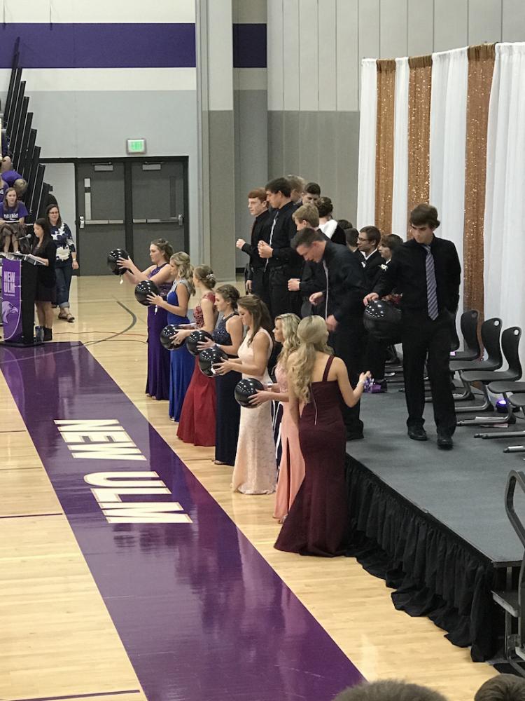 Queen candidates and their escorts getting ready to find out who is homecoming queen