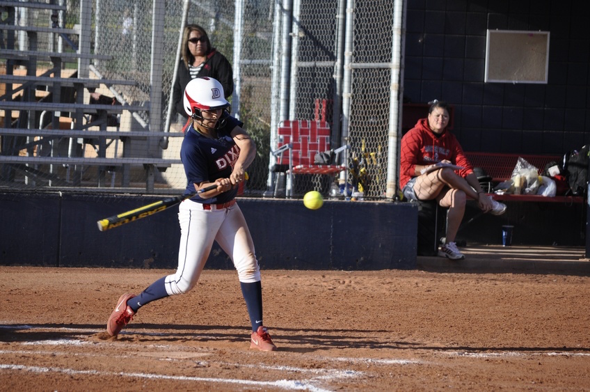 STRIKE THREE batter swings at third strike in a softball game