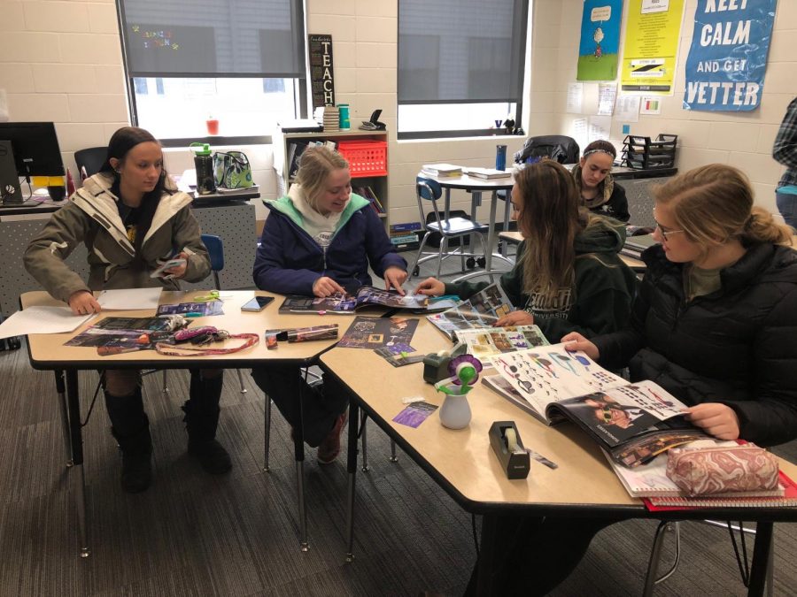 PROM COMMITTEE AT WORK junior girls work on finding ideas during a meeting over lunch