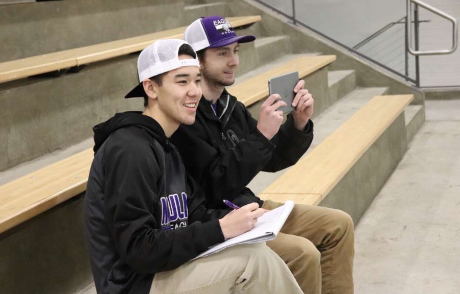 HARD AT WORK The hockey managers in action as they film and record stats for the game.