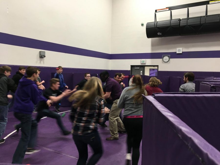 EVACUATION Vice Principal and Activities Director, Troy Guentzel, poses as a shooter. A pseudo-classroom is tasked to evacuate the room while fending the assailant off with foam balls. 