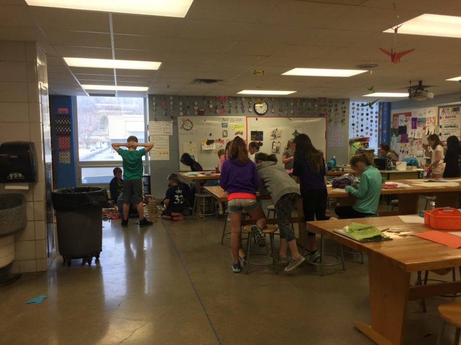 4th grade students gathering supplies and working on their art projects