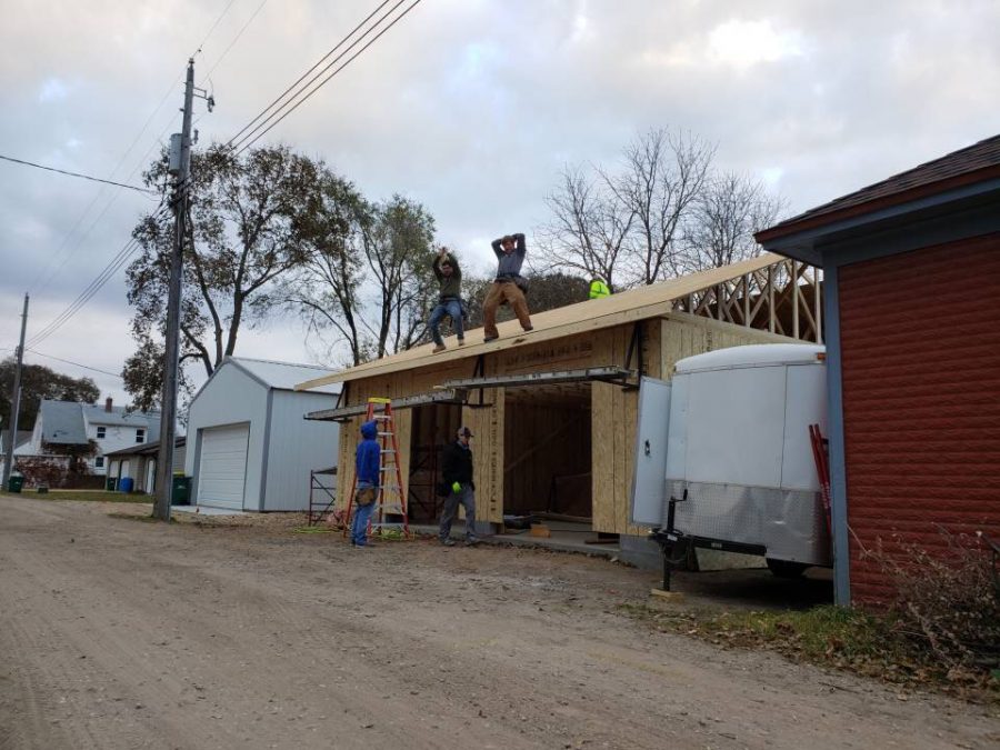 New Ulm Residential Construction class gets a little distracted while they're putting up plywood