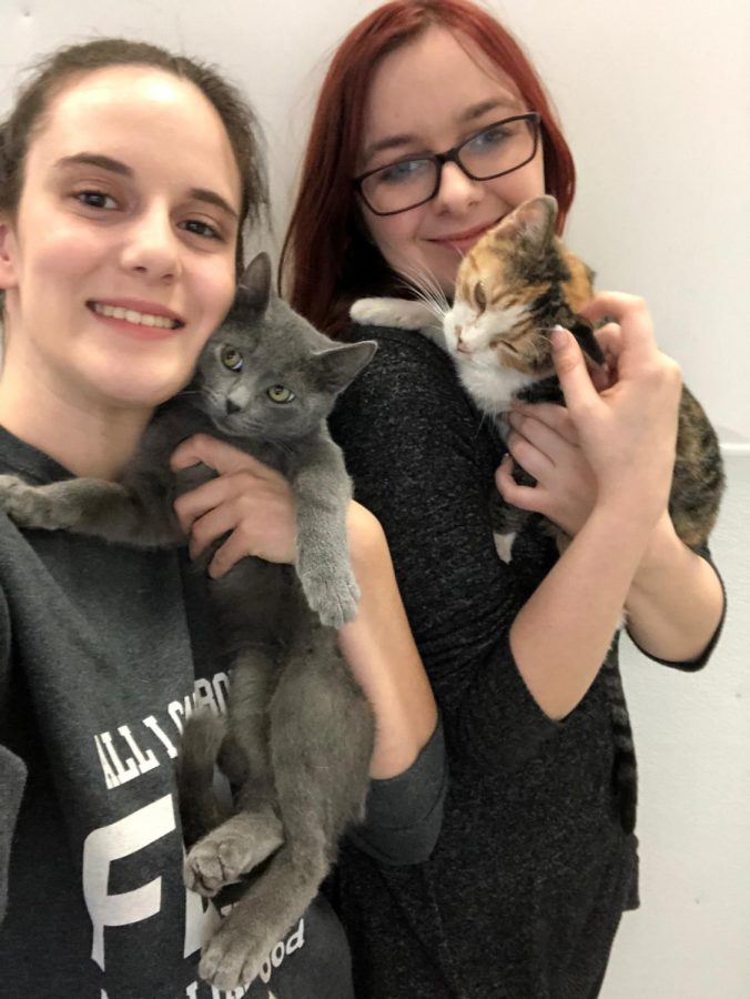 Senior volunteers Ashley Crowder and Lexi Krosch pose with Elliot and Sadie