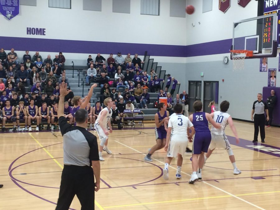 Senior Braden Zimmerman takes a free-throw shot as the New Ulm Eagles Boys Basketball team clinch their first win of the season. 