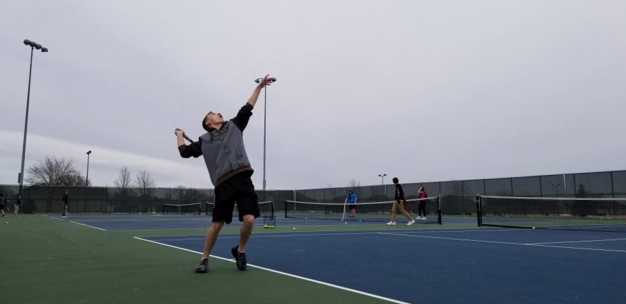 Justin Shapekahm serves it up on the tennis courts.