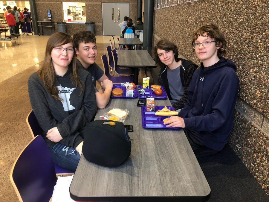 A couple of younger kids eat lunch in the lower commons.