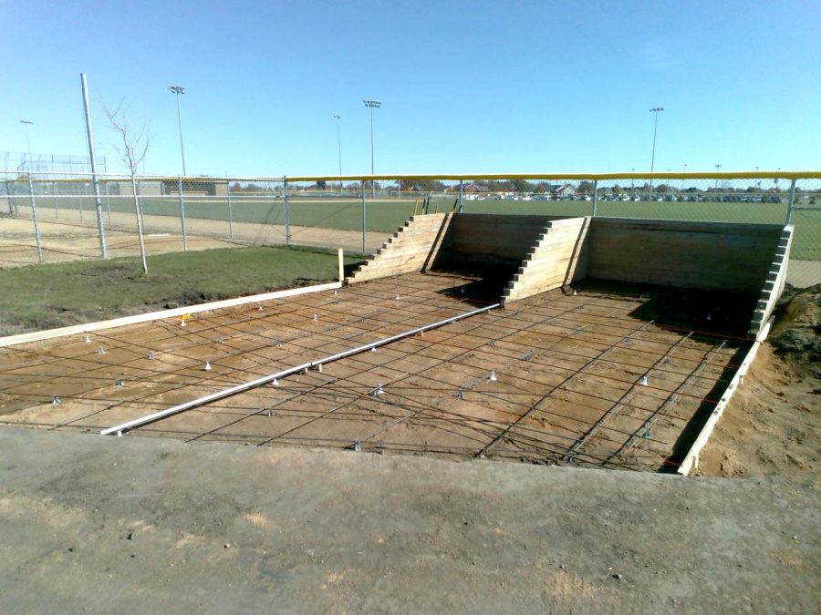 Forming up the area where concrete is to be poured for sand for the ball fields.