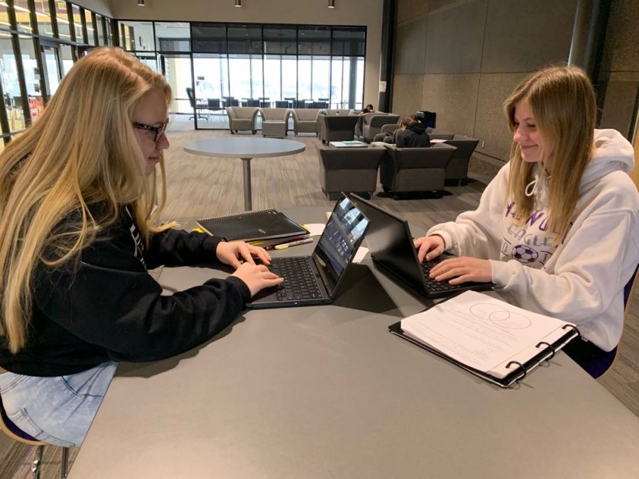 Seniors Brenna Barstad and Rebekah Friendshuh working on homework on their chromebooks in the upper commons