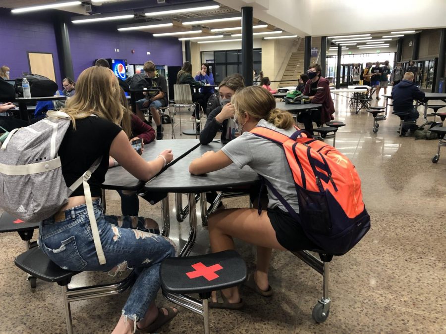 Students sitting at the correct spots at the lunch tables.