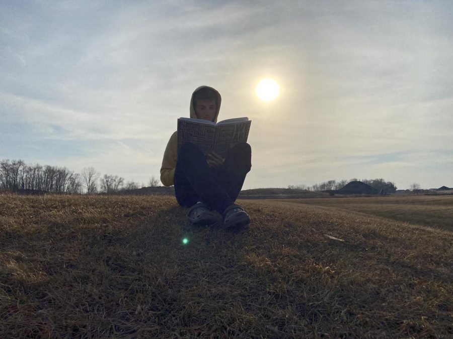 Senior yearbook student Cody Hamelau working on the yearbook on a beautiful Tuesday afternoon