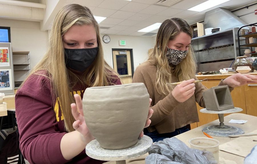 Senior students Abby Bianchi and RyAnn Miller working hard on their coil pots.