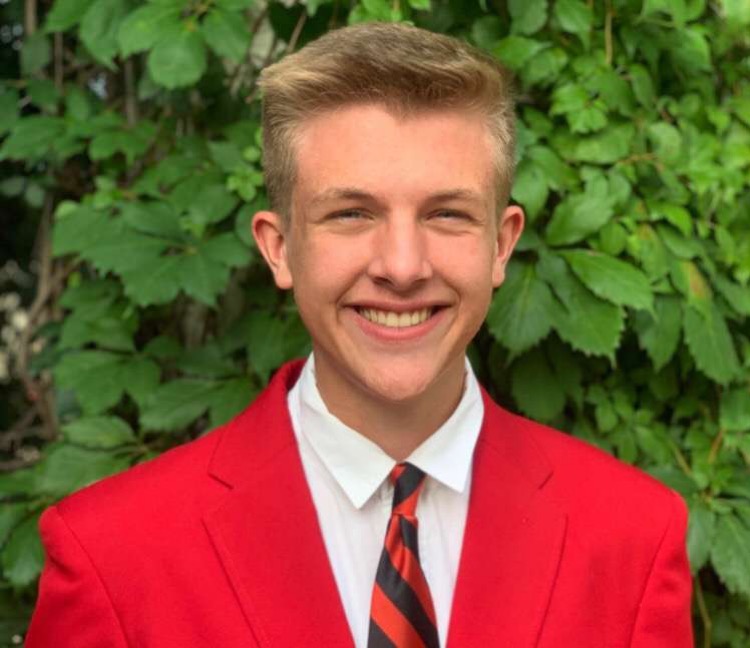 Sophomore Nathaniel Janssen in the FCCLA red Blazer after being elected VP of Marketing