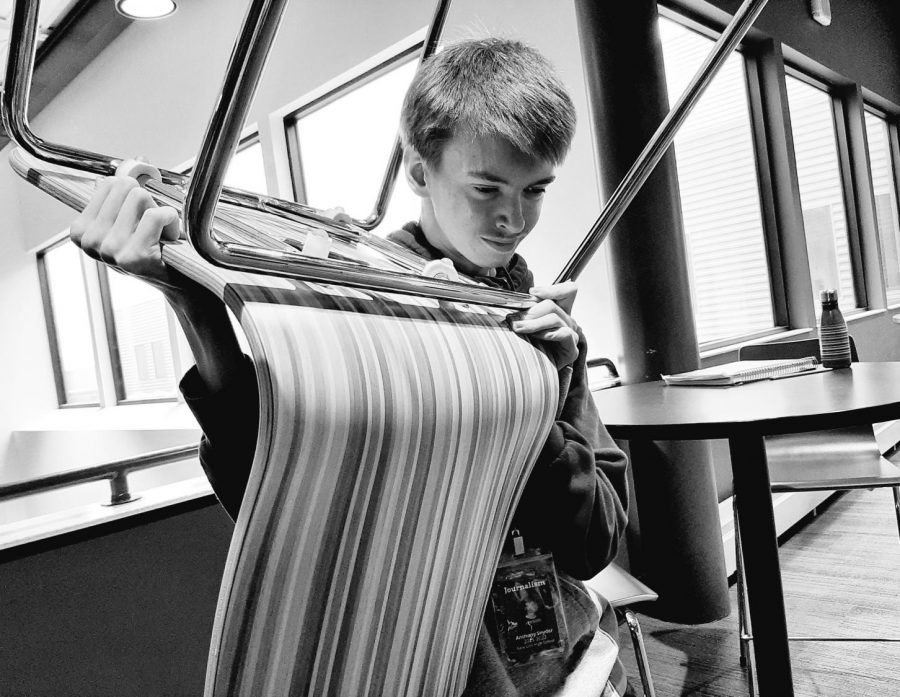 Work Experience student Anthony Snyder labors away at New Ulm High School to make sure the tables and chairs are properly arranged.