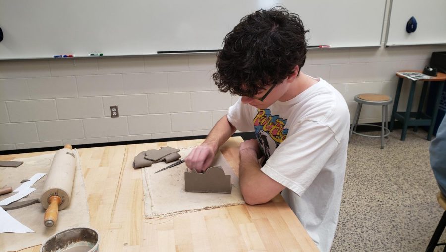 Vinnie Leske making a box in Pottery class. 