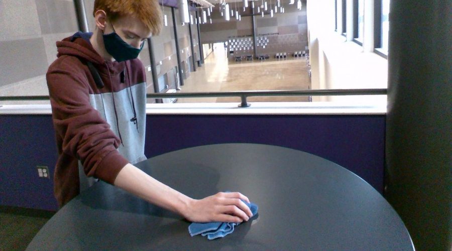 Work Experience student Anthony Snyder is hard at work to make sure the tables at New Ulm High School are clean.