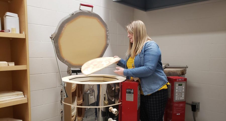 Ms. Page taking out kiln furniture. 