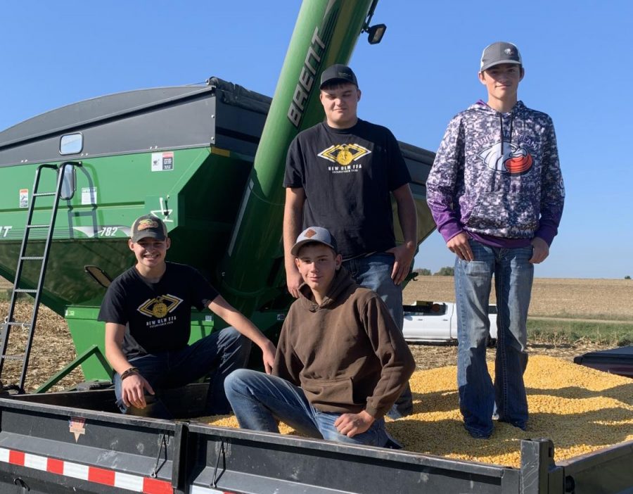 FFA members pose on top of just some of the corn donated for the corn drive.