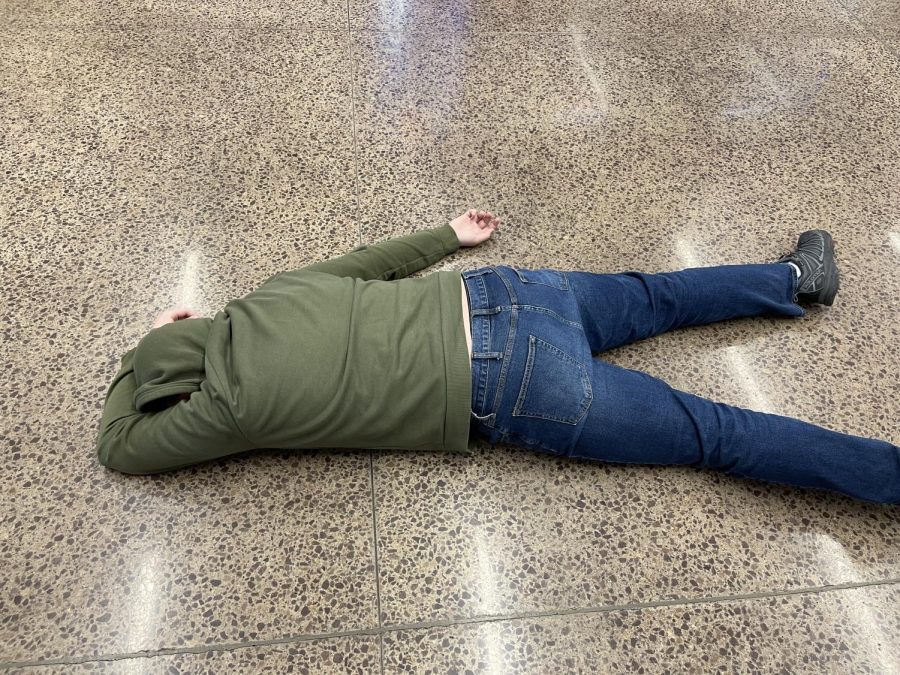 On Feb. 3, Andrew Mages, a senior at NUHS lays unconscious on the floor at NUHS after slipping on wet floors from the mop. Lately many students at NUHS have had the same unfortunate fate with the common question being when will it stop? "There should be wet floor signs, this is an outrage," Mages said.