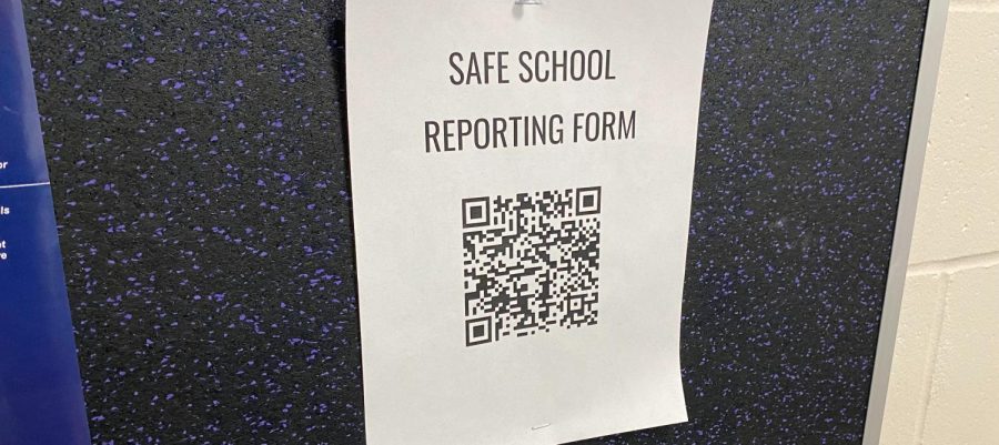 A sign to help the students of New Ulm to report abuse or harassment from the comfort of their devices. 