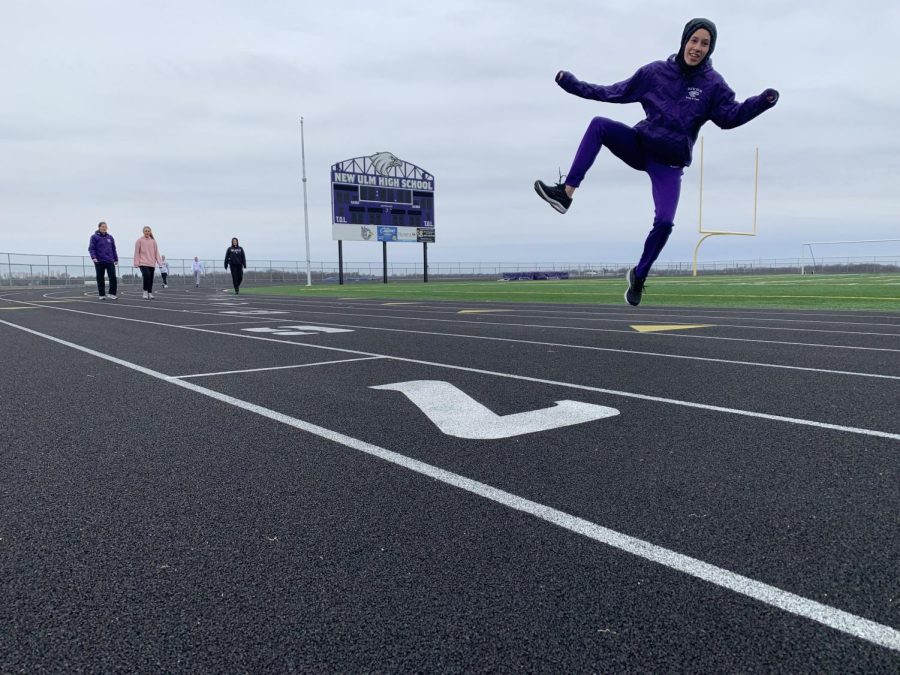Junior track member Emily Pearson leaps for a snapshot.