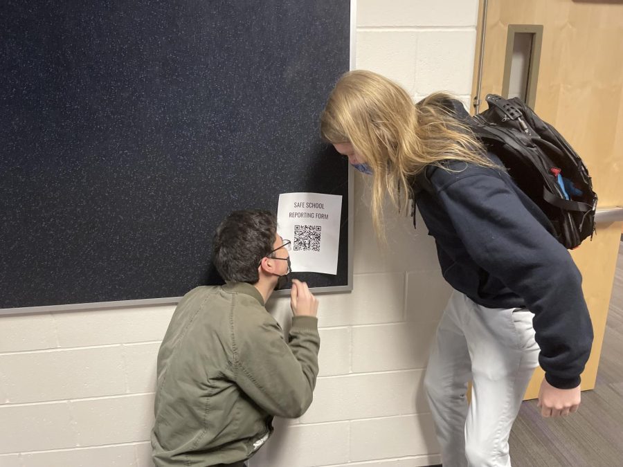 Seniors Nathan Zacate and Graham Wilkins ponder and look to see what the safe school reporting form is all about.