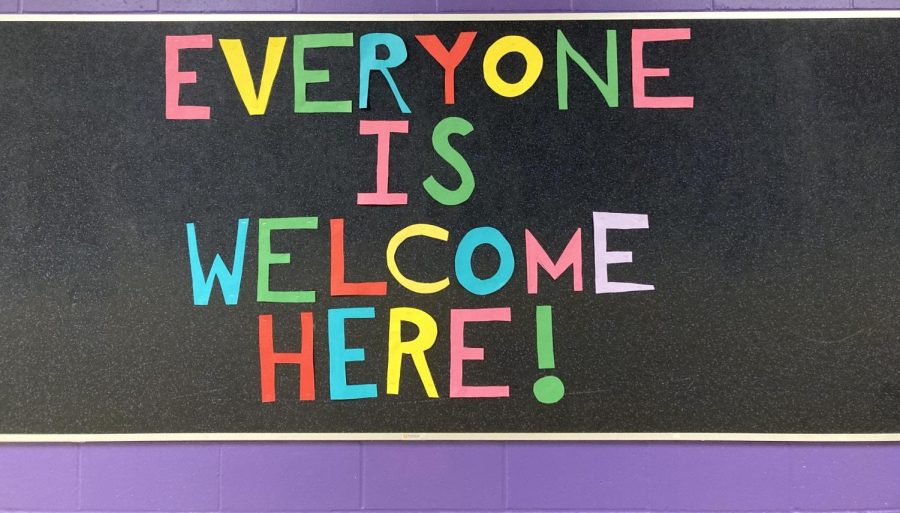 Colorful letters located in the hallway of New Ulm High School near the commons share a friendly message.
