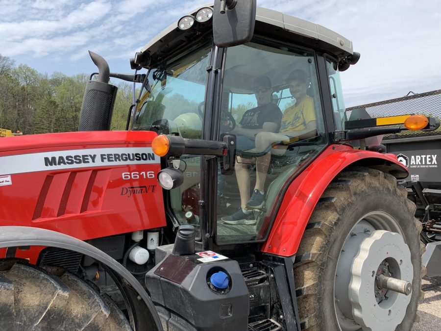 Jaden Miller driving his fathers tractor into the spring ag show