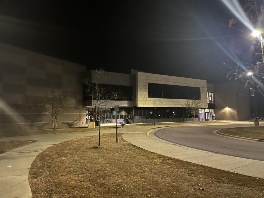 The night sky hangs over the school as students leave Wednesday night class. 