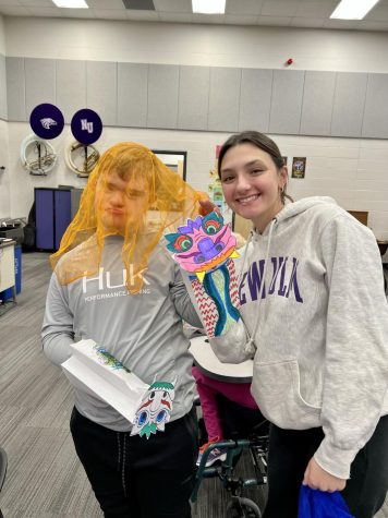 Sophomore Bryce Braulick (left) and Senior Thia Achman having fun in the new class offered at New Ulm High School on Tuesday morning. Music class is both new to the special education kids and the aides. I really like being able to do something different. It is fun and you get to experience new activities with the kids, Achman said.