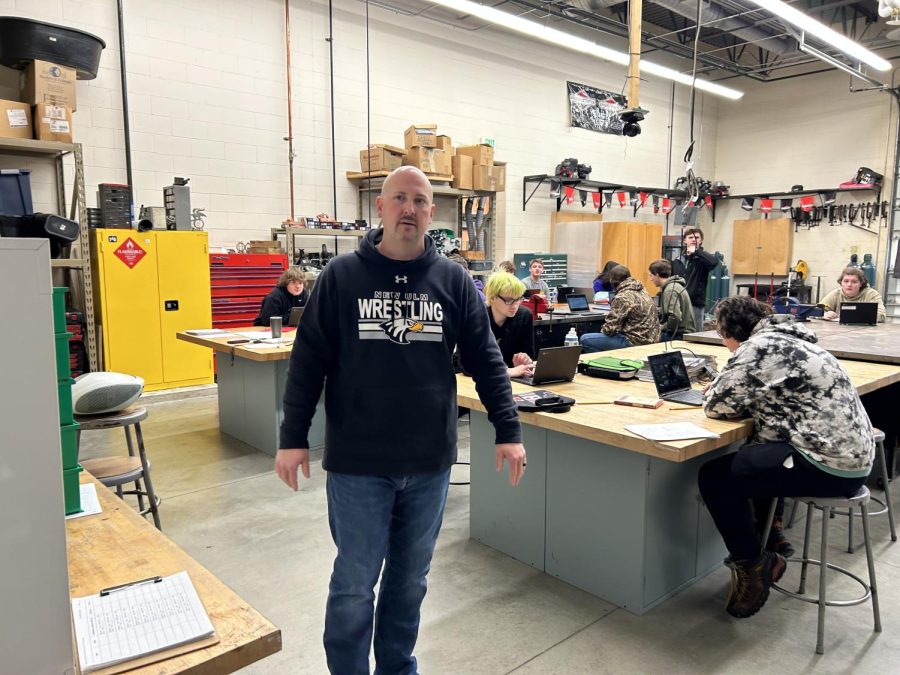 Mr. Nelson greets students at the door of his metals class. 