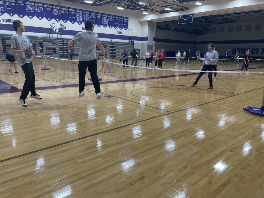 Junior Joey Kotten leaping into action as his teammate Senior Mitchell Schotzko watches. They are playing against Senior Leigha Grussendorf and Senior Dawson Kraus.