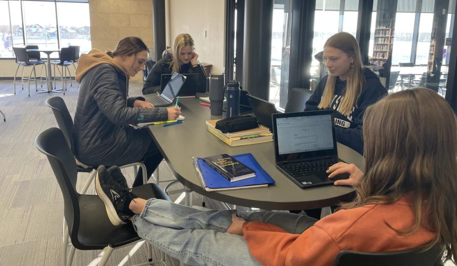 Students working on their homework in the library due to the commons being full.