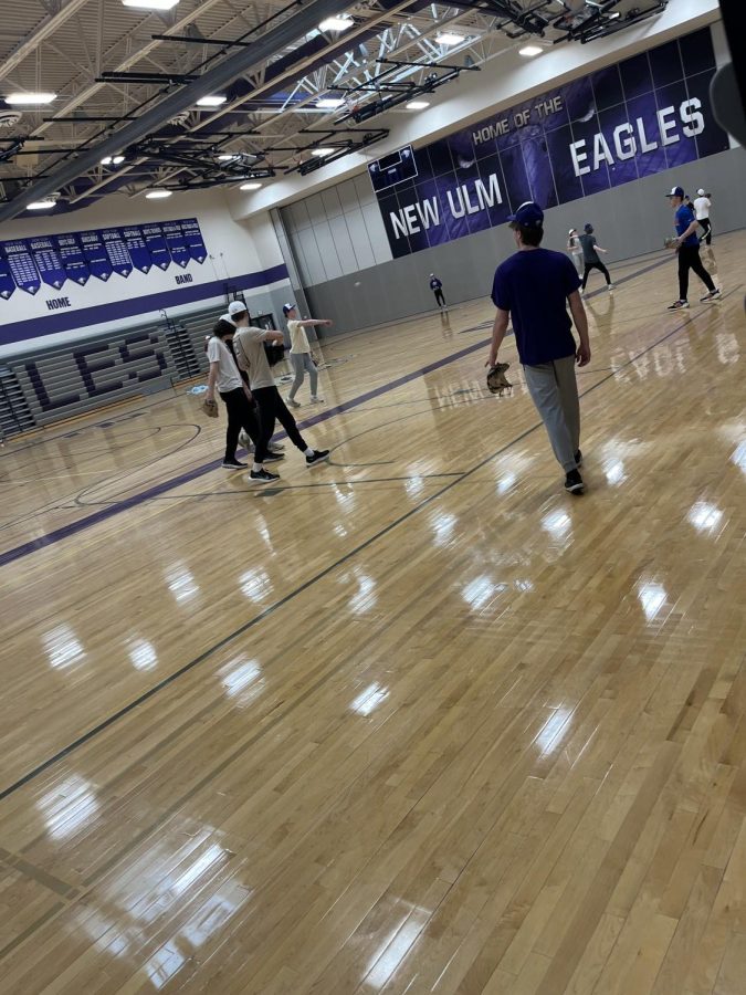 Baseball Players finish up playing catch on the first day of practice