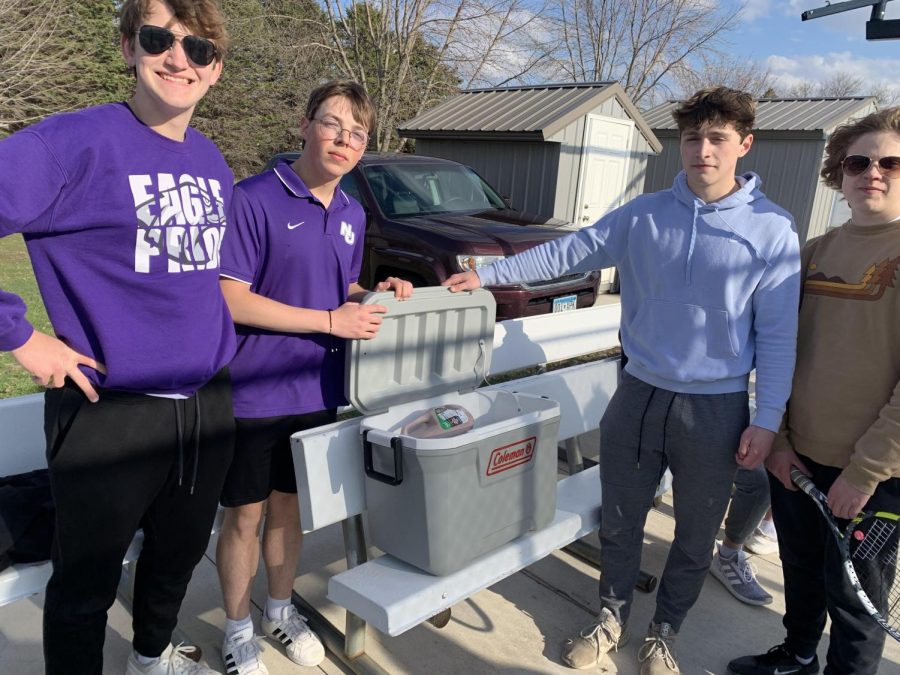 From left, Ben Groebner, Dylan Jackson, Ben Brownfield, and Henry Albrecht show off their gallons of chocolate milk generously donated by parents.