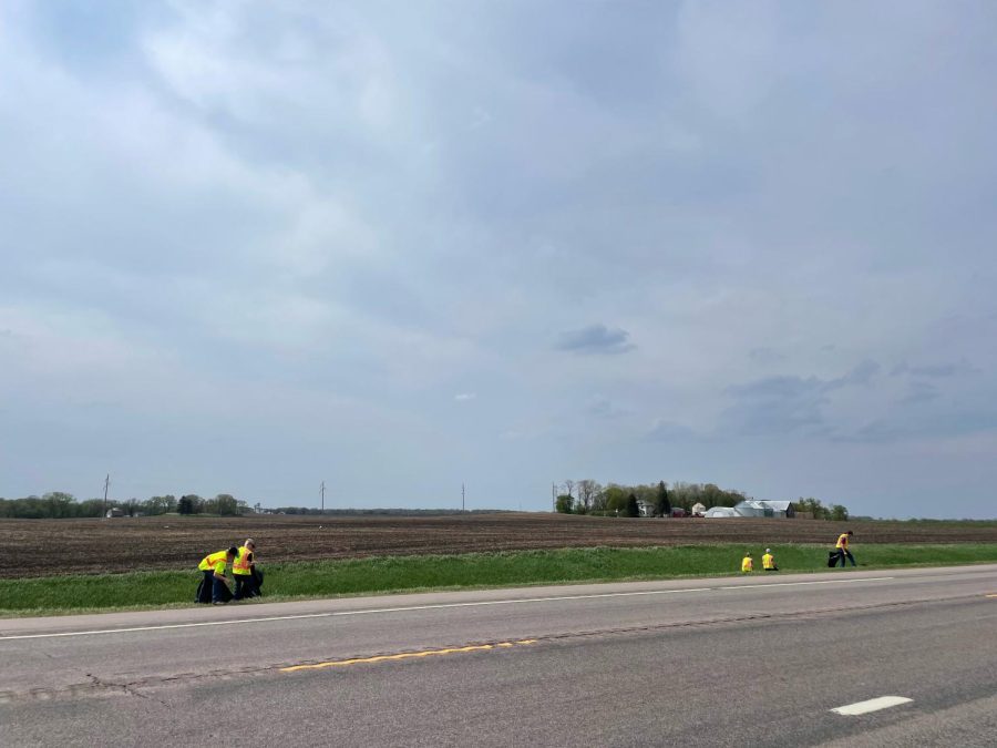 FFA members walk along Highway 15 picking up trash from over the winter.