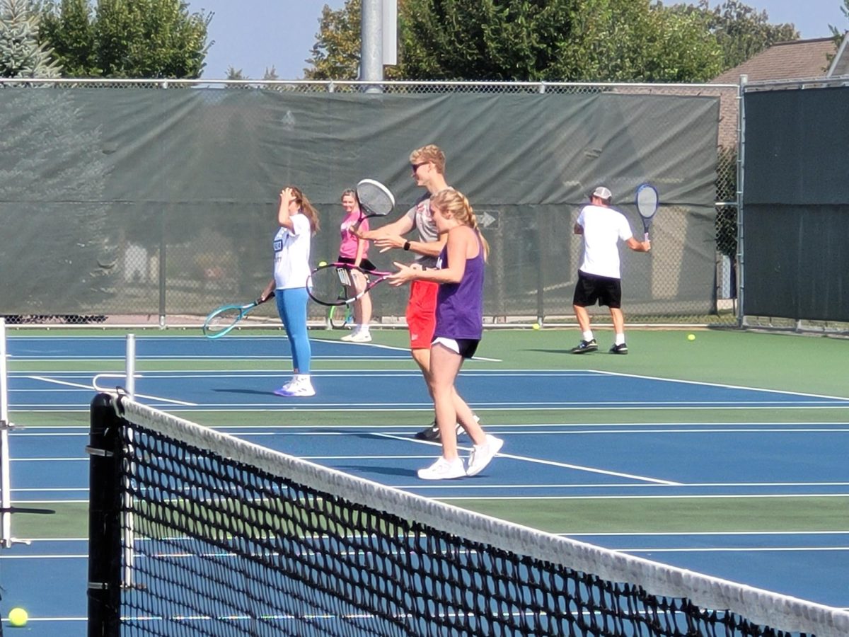 Practicing Hard To Win The Next Game. The tennis players sharpen each others skills. One Player said "we always gotta put our A game on." 