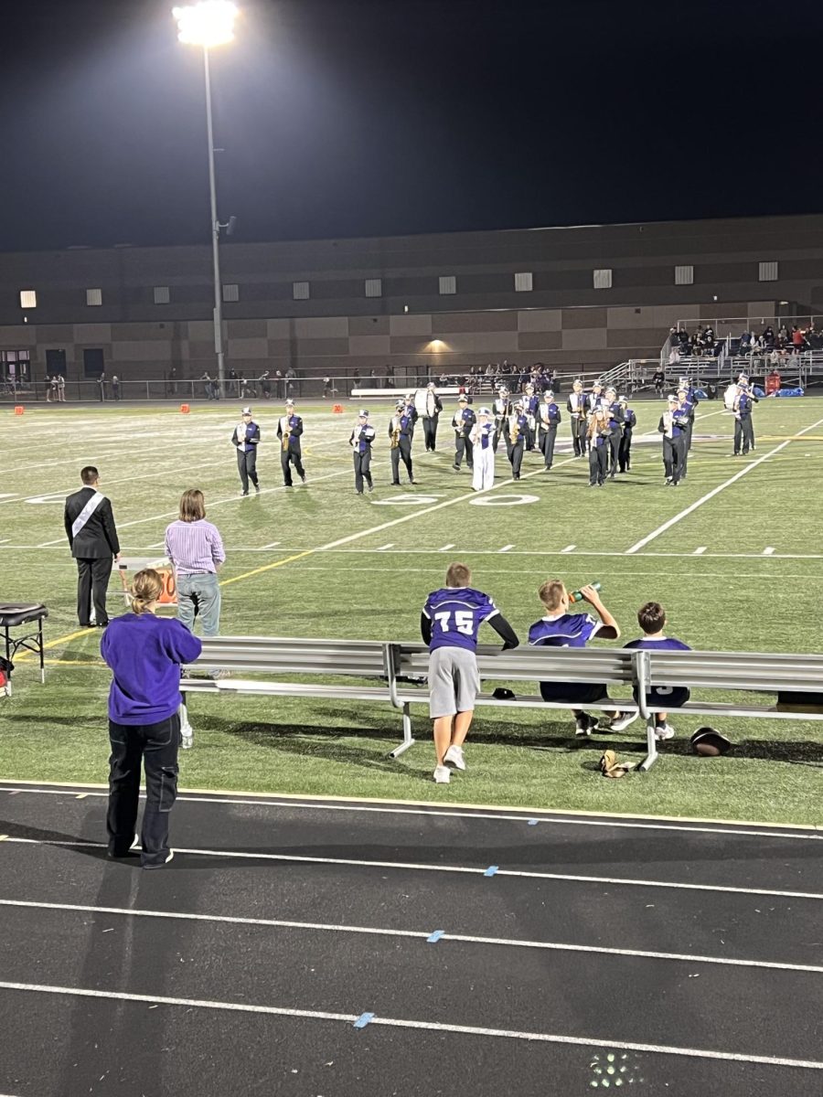 The marching band starts to play at the beginning of half time  
