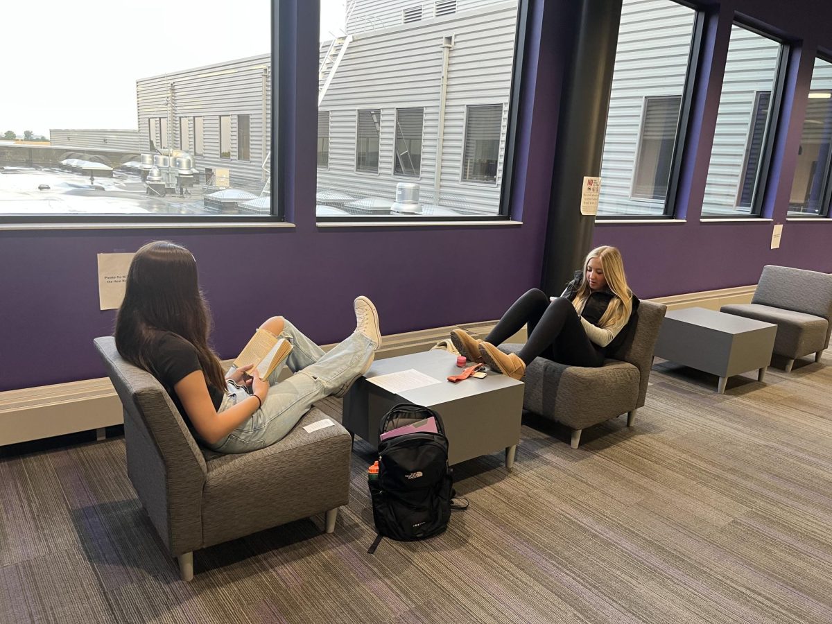 Junior Makenna Wendorff and Sophomore Grace Henn are working hard before the 8 o'clock bell in the eagle lounge area. Sophomores have started reading "Of Mice in Men" in English 10 "I'm not a big fan, the book is kind of boring" was how Grace described the book. "I don't have any homework because I'm responsible, but I am getting annoyed on the amount of homework for only the third week of school" were the thoughts of Makenna. 