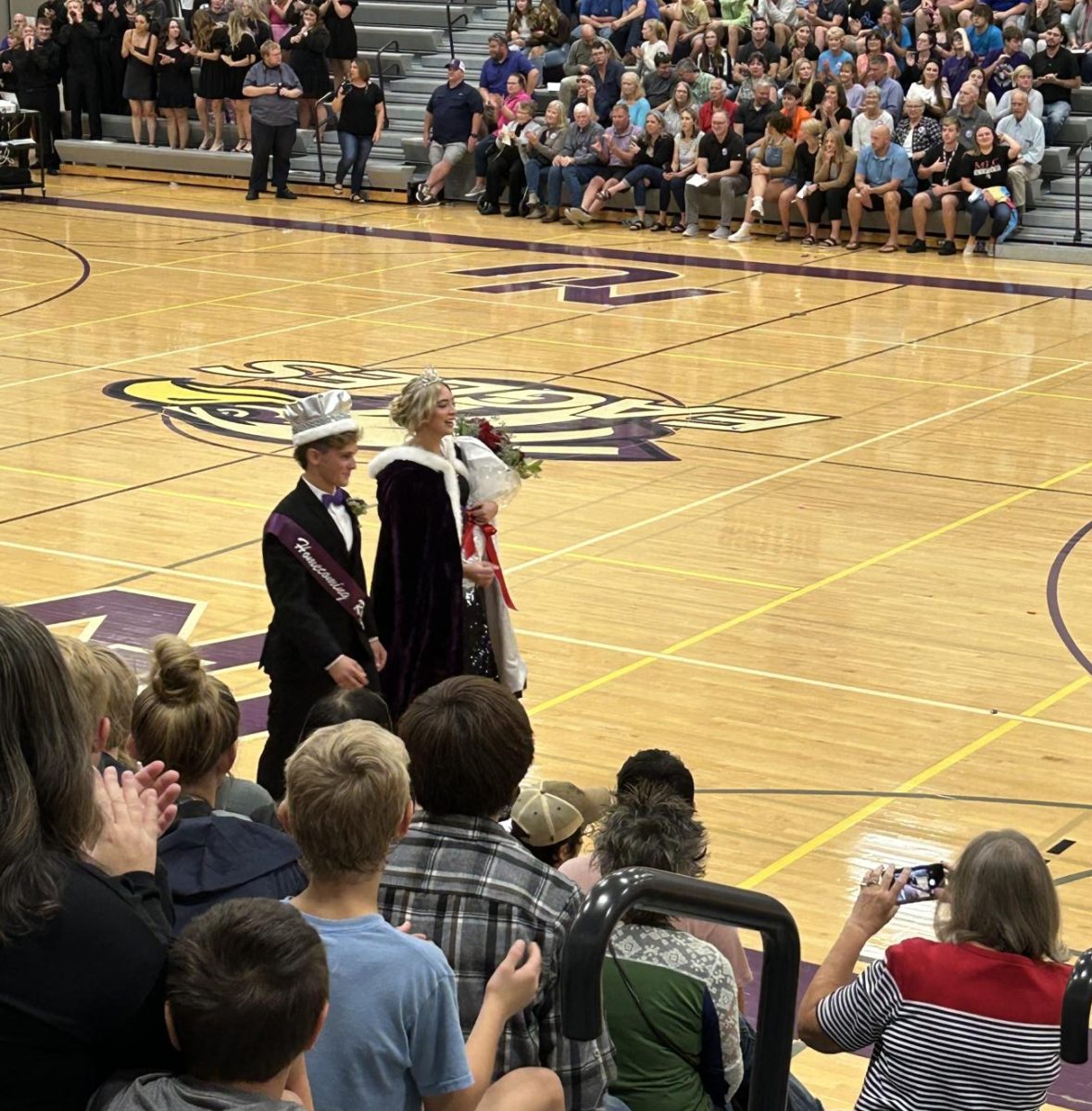 Seniors Bryer Hoffmann(left)and Alex Groebner(right) walk around the gym after being crowned homecoming royalty 