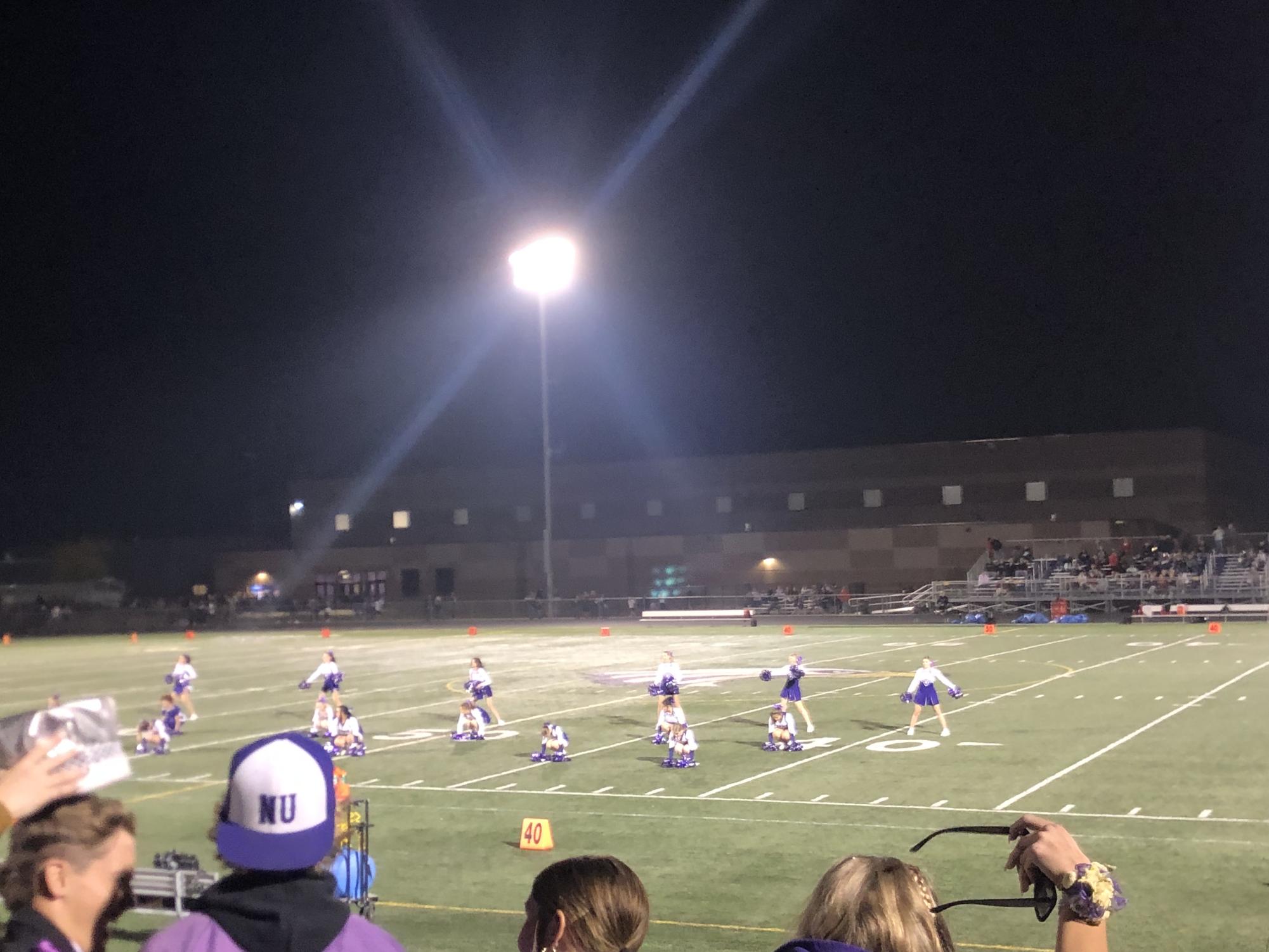 New Ulm High School cheerleaders perform their halftime routine at the homecoming football game Friday night.