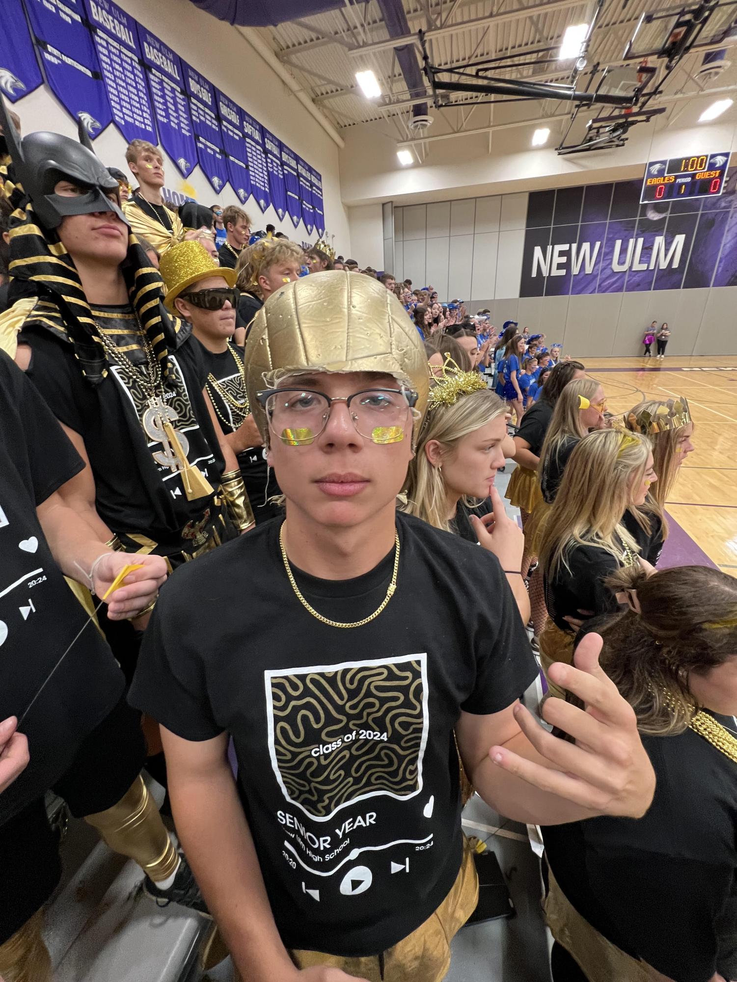 Blaine Olson poses with a gold volleyball on his head.